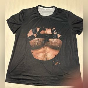 T-shirt showing a muscled hairy chest with harness. Be a tough manly-man!